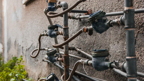 Water meters attached to pipes on a wall