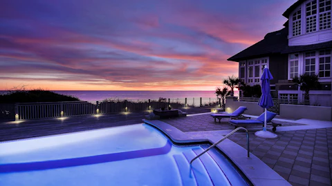 Backyard swimming pool beside a house